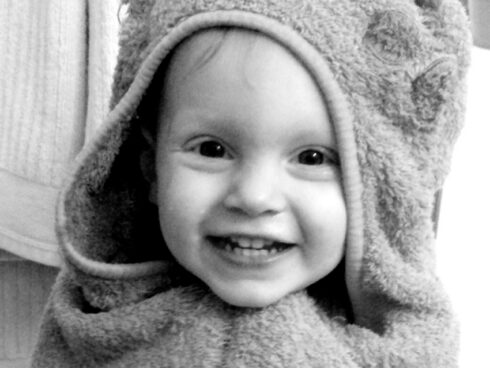 Young boy wrapped in a towel