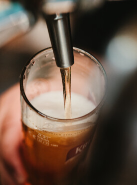 Beer being poured into a glass from a tap at River Bluff Brewing